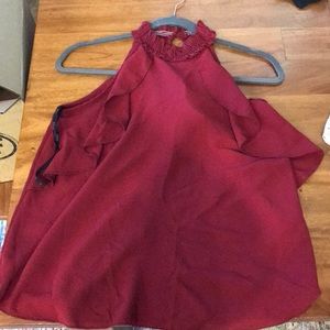 Maroon sleeveless top with ruffle accents